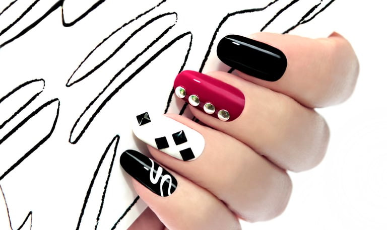 a person's hand with a black and white nail polish