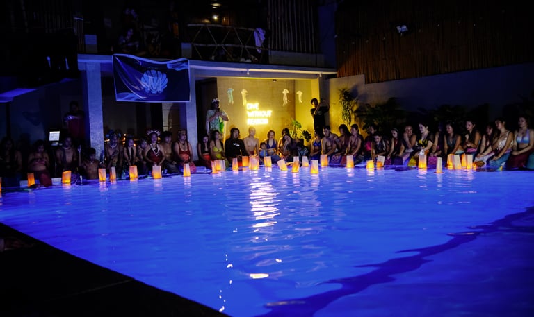 mermaid event at night in beautifully lit swimming pool with Asian lanterns