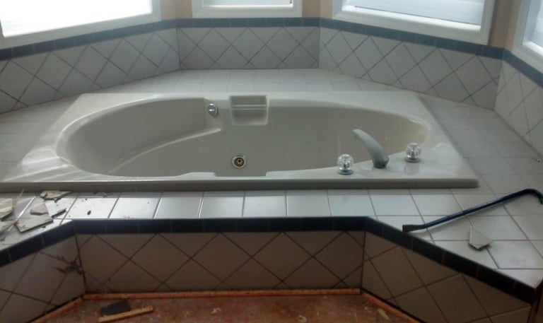 Before demoing tile around the tub surround .