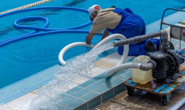 man cleaning pool