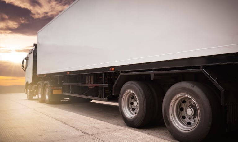 a truck with a trailer parked on the side of the road
