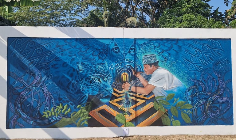 Indigenous street art mural featuring a shaman, a jaguar, and an owl in vibrant blue tones.