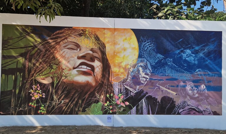 Vibrant outdoor mural featuring indigenous figures, a glowing moon, and a soaring eagle.