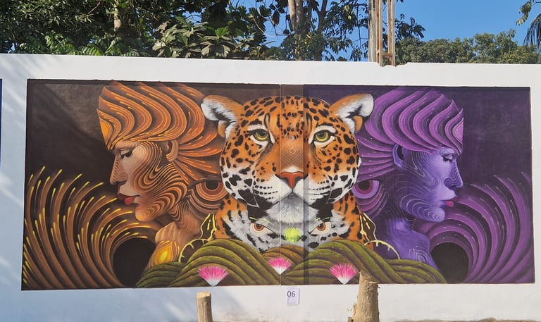 Street art mural featuring a central leopard face flanked by two profile portraits of stylized women.