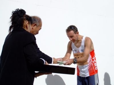 Coach Scott Brown receiving a prize for an age graded win in the Kawachinagano half marathon.