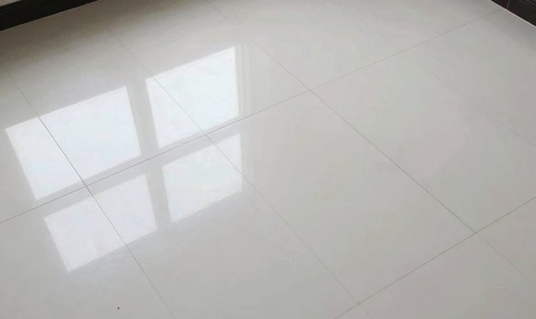Close-up of skilled craftsmen applying precise tile work in a sophisticated interior.