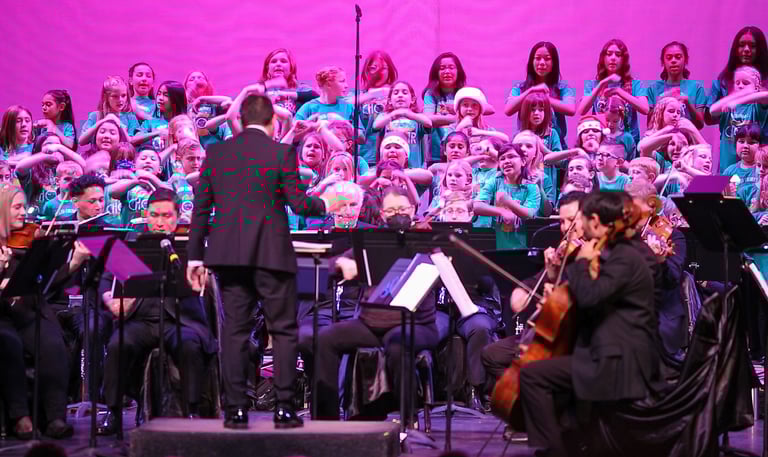 Children in Merced singing in a holiday choir