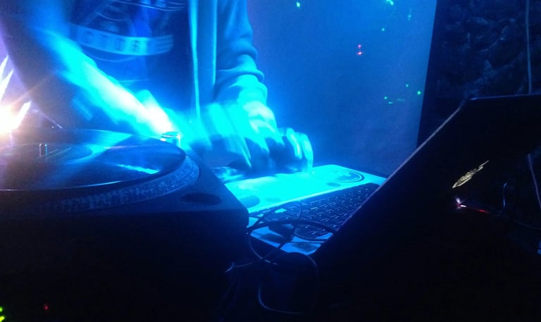 Vibrant neon-lit DJ turntable in Garden Club Alcudia