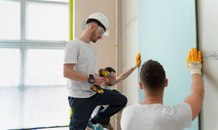 handyman team installing wall panels in an Auckland home