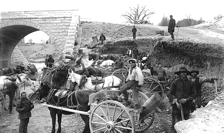 Reservoir laborers loading rocks into a pony cart