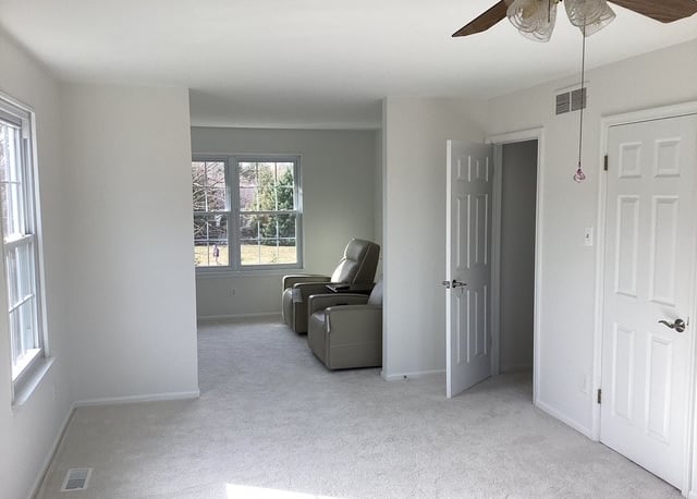a finished painted bedroom wit chairs