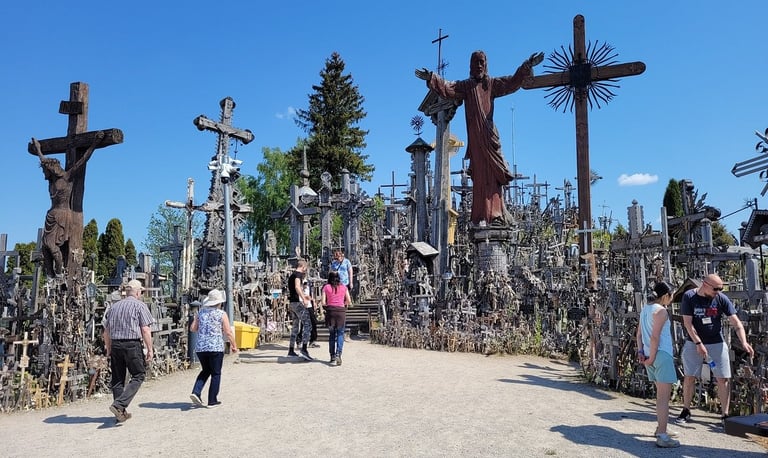 Guide Simas walking with tourists through the Hill of Crosses pilgrimage site in Lithuania 2