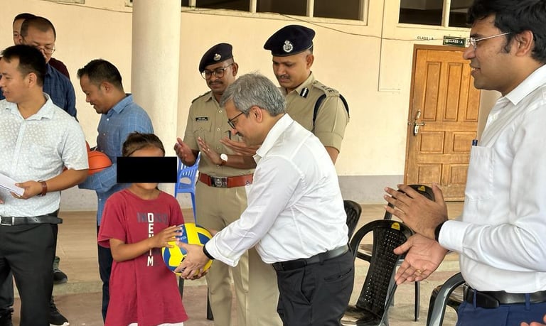 Manipur chief secretary Dr Vineet Joshi  presents gifts to children at a relief camp