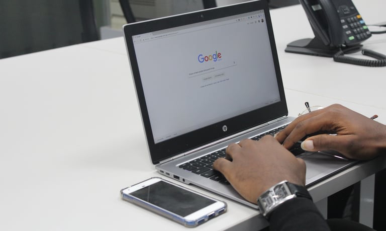 man typing on laptop