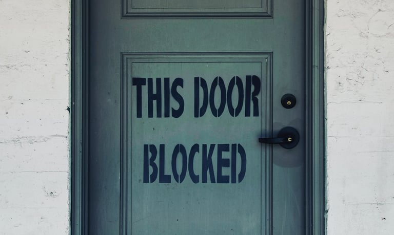 Door with the words "This Door Blocked"