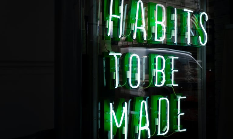 neon sign reads "Habits to be Made"