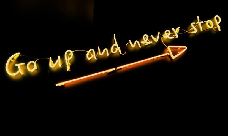 sign with arrow pointing up reading "Go up and never stop."
