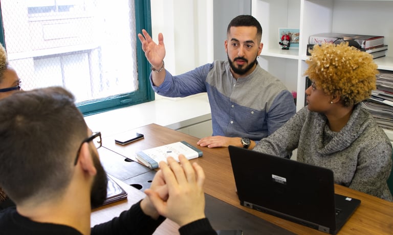 group of young people working/discussing in office 