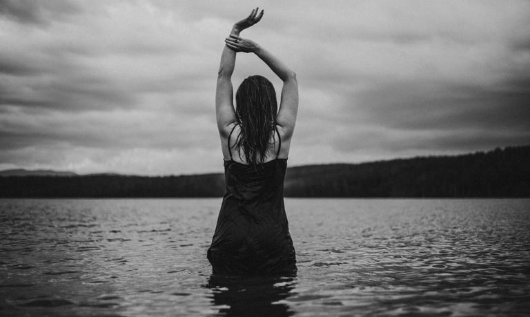 a woman in a swimsuit standing in the water