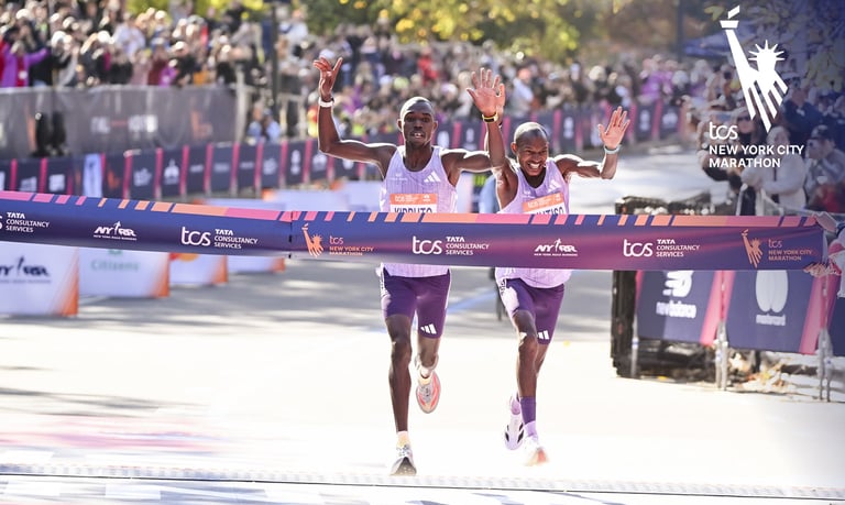 Benson Kipruto (left) and Alexander Mutiso (right) in a photo finish sprint at the 2025 NYC Marathon finish line, showing the