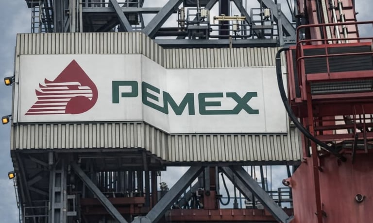 The Pemex logo and eagle emblem displayed on an industrial offshore oil drilling rig platform.