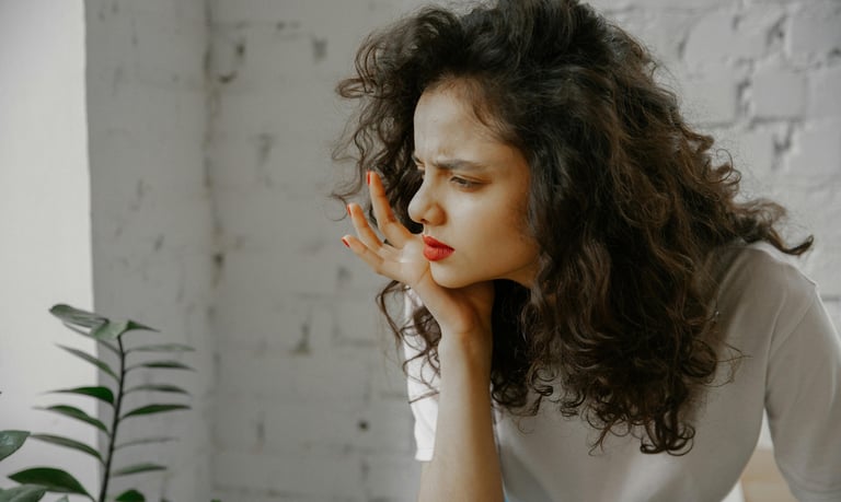 Woman with hand on chin, looking confused