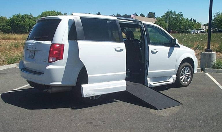 Side view of 2019 Dodge Grand Caravan SXT with the VMI In-Floor Ramp being Deployed