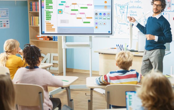 a man standing in front of a class room