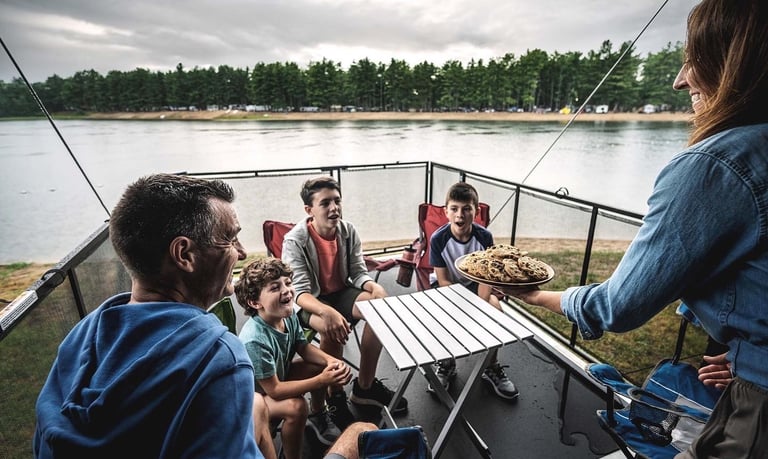 a family eating cookies on an RV deck