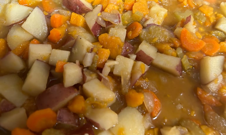 Vegetable soup with a blend of potatoes, sweet potatoes, carrots, celery and broth shown.