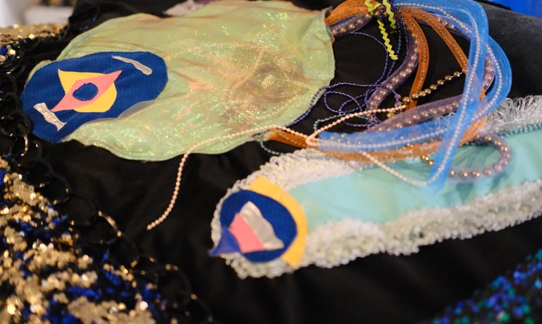 Two imagined underwater creatures that resemble jellyfish and a slug made out of textiles