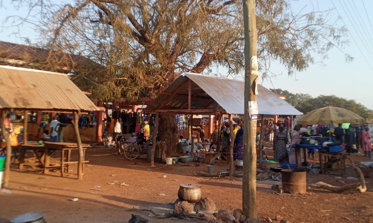 a group of people standing around a tenta, rural market and station market and a station