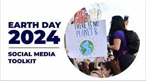 a woman holding a sign that says earth day