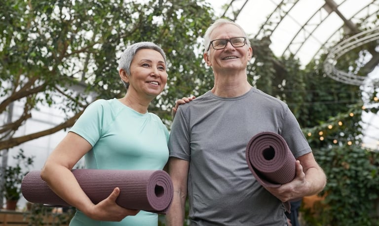 Relationships and Longevity - a man and woman holding yoga mats in a greenhouse