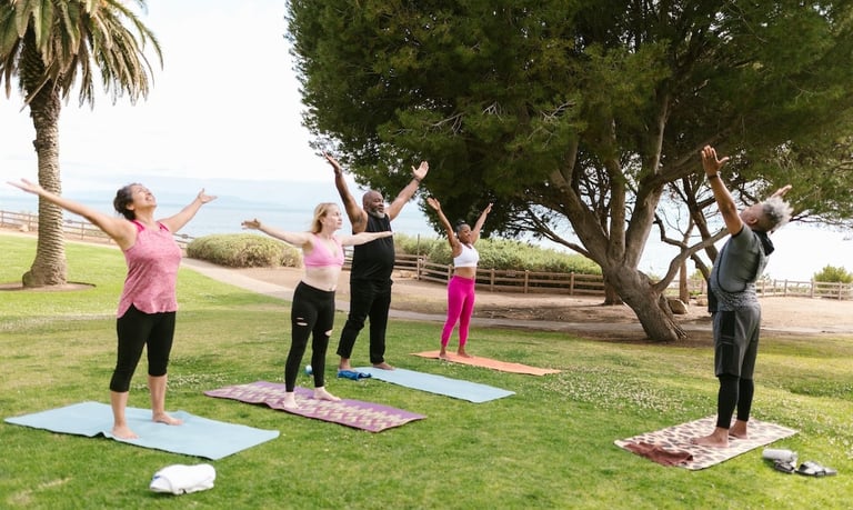 wellness practices - a group of people doing yoga on a sunny day