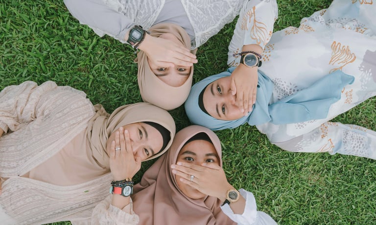Friends lying together on grass during lifestyle photoshoot at Candi Beach Resort Karangasem Bali