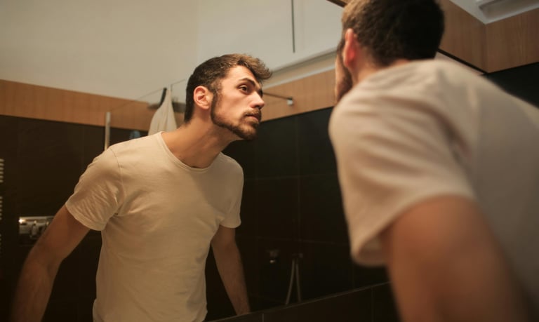 Man looking at himself in the mirror