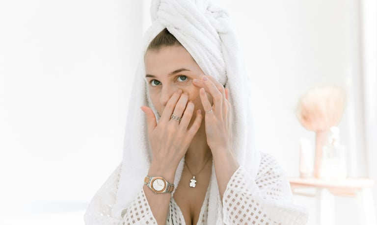 A  woman applying eye cream