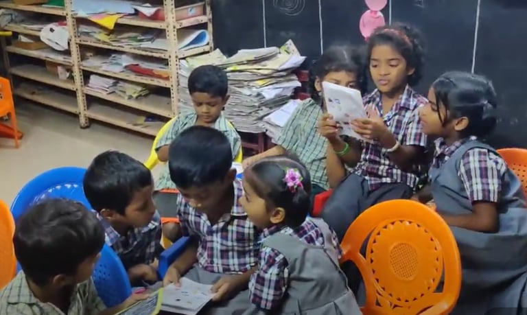 a group of children sitting around a table and studying