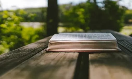 a book sitting on top of a wooden table showing bible answers