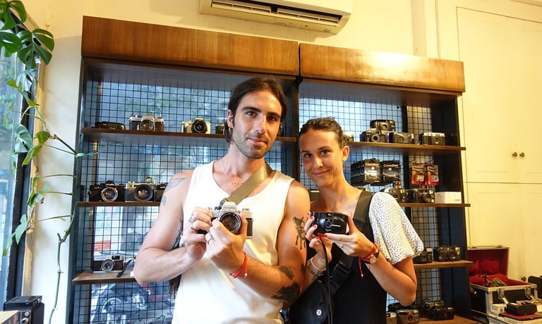 Photographers in Saigon holding analog cameras