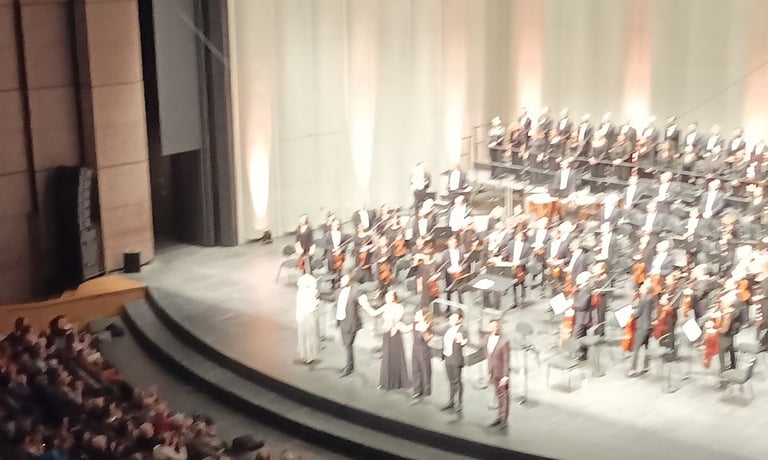 The choir, orchestra, conductor and soloists all take a bow.
