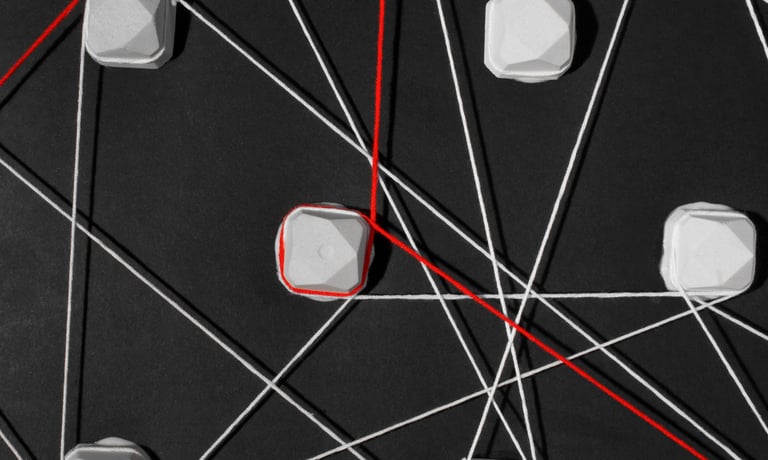 Interconnected web of white and red strings representing complex data network connections on a black background.