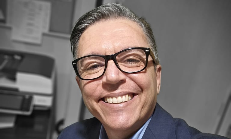 a man in a suit and tie smiling