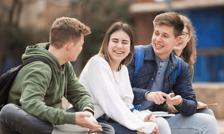 a group of young people sitting on a bench