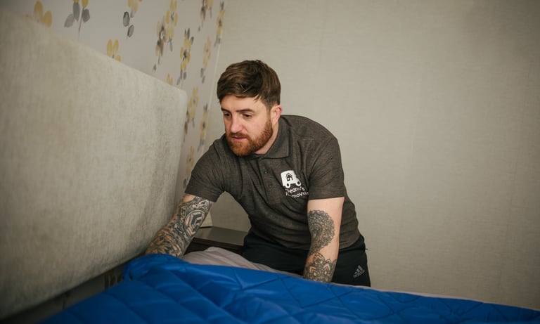 deano removals man covering a bed during a removals job in the city of worcester