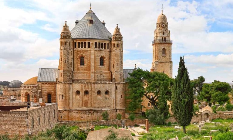 Dormition Abbey at Mount Zion, Jerusalem against a cloudy blue sky