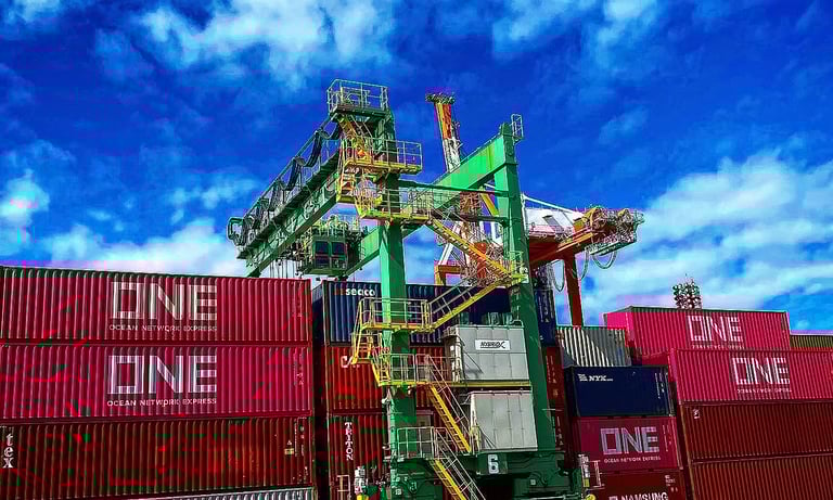 A green industrial gantry crane stacking pink ONE and silver Maersk shipping containers at a busy port.