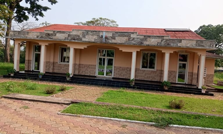 a house with a red roof and a brick building
