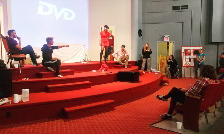 a group of people standing on stage having rehearsal